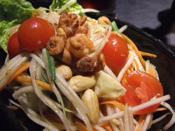 classic spicy papaya salad with cherry tomatoes and roasted nuts at Suda classic spicy papaya salad with cherry tomatoes and roasted nuts at suda