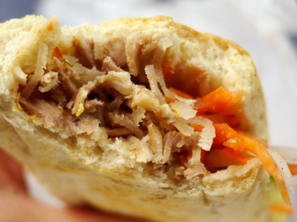 close up of shredded caramel pork baguette from banh mi bay