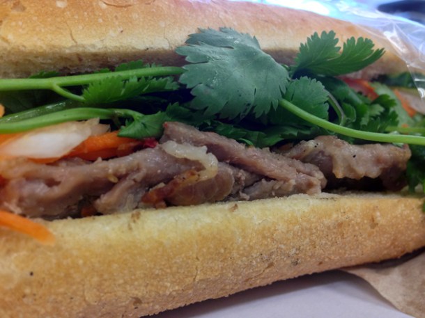 close up of spiced pork baguette at banh mi bay