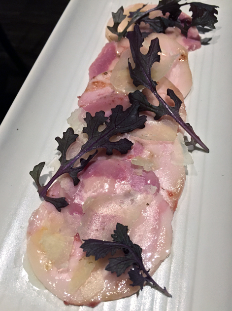 pork belly slices with apple dressing and pecorino cheese at the ninth