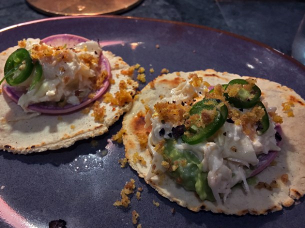 crab and pickled onion pork skin tacos at temper