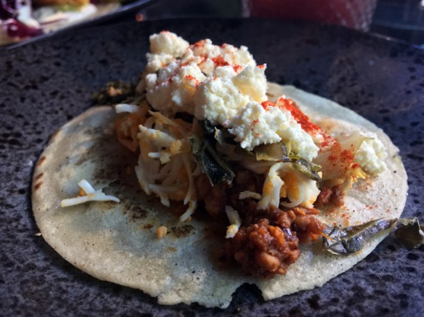 addis doro wat chicken and collard green tacos with goat's cheese at tienda roosteria