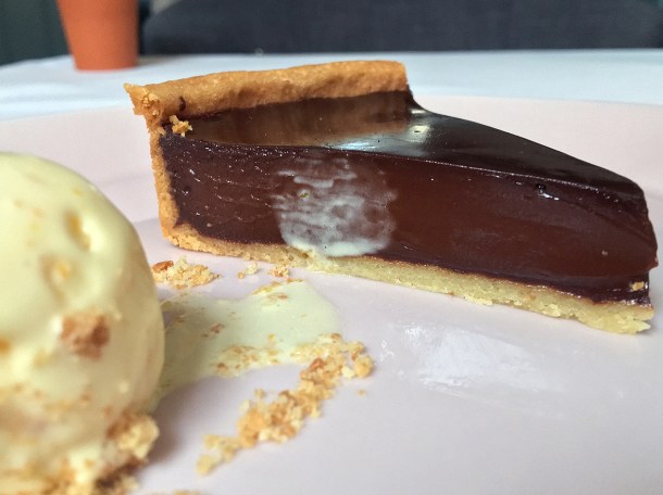illustrative photo of the dark chocolate tart with orange ice cream at Myrtle
