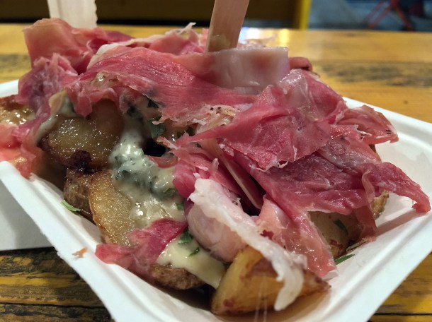 illustrative photo of the potato Wedges topped with raclette, ham and fourme d'ambert from Champangne Fromage at Mercato Metropolitano.
