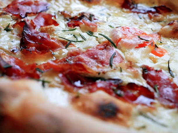 illustrative photo of the speck, egg and confit garlic pizza from Caravan Bankside